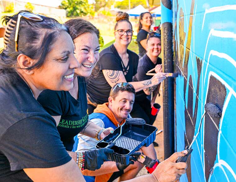 Priti Maya Tayal of Hale Opio leads the Leadership Kauai team on Saturday, Feb. 15, 2025 at the developing Drive With Aloha mural at the Kauai High School R Building. Hale Opio Kauai